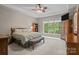 Main bedroom featuring a large window, lots of natural light, and carpeted floor at 154 Hunters Hill Dr, Statesville, NC 28677