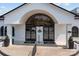 Elegant clubhouse entrance with arched glass doors, black accents, and manicured landscaping at 154 Hunters Hill Dr, Statesville, NC 28677