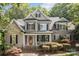 Charming two-story home featuring a red front door, manicured landscaping, and a welcoming front porch at 154 Hunters Hill Dr, Statesville, NC 28677