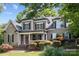 A beautiful two-story home features a charming front porch, well-manicured landscaping, and a striking red front door at 154 Hunters Hill Dr, Statesville, NC 28677