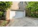 Side entry garage with white door and concrete drive, adding convenience and curb appeal at 154 Hunters Hill Dr, Statesville, NC 28677