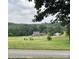 Scenic golf course view showcasing lush fairways and greens, complemented by beautiful homes at 154 Hunters Hill Dr, Statesville, NC 28677