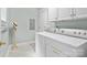Bright laundry area featuring washer, dryer, and ample storage space with geometric design tile flooring at 154 Hunters Hill Dr, Statesville, NC 28677