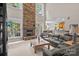 Spacious living room with a stone fireplace, large windows, and an open layout to the kitchen at 154 Hunters Hill Dr, Statesville, NC 28677