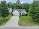 An aerial view shows a well-kept home with mature trees, a long driveway, and a lush green lawn at 199 Ashmont Dr, Kannapolis, NC 28081