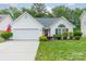 Charming single-Gathering home featuring a well-manicured lawn, two-car garage, and inviting curb appeal at 199 Ashmont Dr, Kannapolis, NC 28081