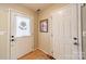 Inviting foyer featuring wood flooring, a storm door with glass, and a coat closet at 199 Ashmont Dr, Kannapolis, NC 28081