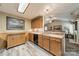 Open kitchen area with wood cabinetry, stone backsplash, and seamless flow to the living space at 199 Ashmont Dr, Kannapolis, NC 28081