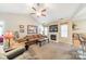 Bright living room with vaulted ceiling, cozy fireplace, and large windows offering ample natural light at 199 Ashmont Dr, Kannapolis, NC 28081