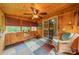 Charming sunroom with wood paneling, natural light, and a comfortable rocking chair at 199 Ashmont Dr, Kannapolis, NC 28081