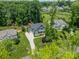 Stunning aerial view of a two-story home with a long driveway and lush green landscaping and mature trees at 208 South Shore Dr, Belmont, NC 28012