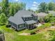 Landscaped backyard with a well-maintained lawn, patio, and charming home exterior at 208 South Shore Dr, Belmont, NC 28012