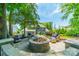 Inviting backyard patio featuring a stone fire pit and cozy seating, perfect for outdoor relaxation at 208 South Shore Dr, Belmont, NC 28012