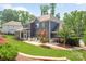 This backyard offers a patio, grill, lush greenery, and a well-maintained lawn at 208 South Shore Dr, Belmont, NC 28012