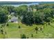 Aerial view of a property with a huge backyard and mature trees bordering the green lawn at 208 South Shore Dr, Belmont, NC 28012