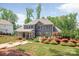 The spacious backyard features a screened-in porch, patio, and lush landscaping at 208 South Shore Dr, Belmont, NC 28012