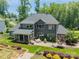 Expansive backyard featuring a patio, screened-in porch, and lush landscaping on a well-maintained lawn at 208 South Shore Dr, Belmont, NC 28012