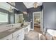 Beautiful primary bathroom showcasing dual sinks, a soaking tub, decorative lighting, and a view to the bedroom at 208 South Shore Dr, Belmont, NC 28012