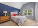 A charming bedroom features a blue accent wall, a large window, and a comfortable bed at 208 South Shore Dr, Belmont, NC 28012
