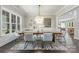 Elegant dining room featuring a modern chandelier, stylish decor, and hardwood flooring at 208 South Shore Dr, Belmont, NC 28012