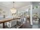 Bright dining room with a chandelier, wood floors, and an open layout that leads to the living area at 208 South Shore Dr, Belmont, NC 28012