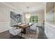 Elegant dining room featuring a modern chandelier, a large wooden table, and stylish chairs near the staircase at 208 South Shore Dr, Belmont, NC 28012