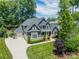 Beautiful exterior showcasing a large two-story home with a three-car garage and well-manicured lawn at 208 South Shore Dr, Belmont, NC 28012