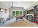 Spacious game room with built-in shelving, a large window, play kitchen, and a foosball table at 208 South Shore Dr, Belmont, NC 28012