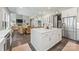 Open kitchen with a large island, stainless steel appliances, a dining area, and hardwood floors at 208 South Shore Dr, Belmont, NC 28012