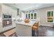 Bright kitchen features white cabinets, an island with seating, stainless appliances, and modern lighting at 208 South Shore Dr, Belmont, NC 28012