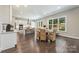 Spacious kitchen with stainless steel appliances, a central island, a cozy dining area, and abundant natural light at 208 South Shore Dr, Belmont, NC 28012