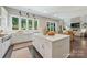Bright kitchen with white cabinets, stainless steel appliances, and a large island, all illuminated by natural light at 208 South Shore Dr, Belmont, NC 28012