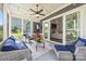Cozy screened porch with comfortable seating, string lights, TV, and sliding glass doors to interior living space at 208 South Shore Dr, Belmont, NC 28012