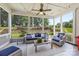 Inviting screened porch with comfortable seating, string lights, a ceiling fan, and backyard views at 208 South Shore Dr, Belmont, NC 28012