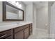 Bathroom with dark vanity, large mirror, and tiled floor at 268 Hillsborough Ln, Rock Hill, SC 29732