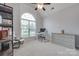 Neutral bedroom with a tall arched window, desk, and dresser for storage at 268 Hillsborough Ln, Rock Hill, SC 29732