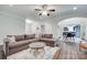 Open-concept living room with comfortable sectional sofa, ceiling fan, and view of dining area at 268 Hillsborough Ln, Rock Hill, SC 29732