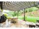 Outdoor patio features a pergola, stone floors, and a dining set overlooking the green backyard at 268 Hillsborough Ln, Rock Hill, SC 29732