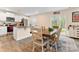 Cozy dining area featuring a wooden table, white cabinets, stainless steel appliances, and sliding glass doors at 2859 Sherrills Stream Dr, Sherrills Ford, NC 28673