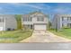 Traditional-style home with a large front yard, attached garage and light colored siding on a sunny day at 2859 Sherrills Stream Dr, Sherrills Ford, NC 28673