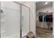 Modern shower with glass doors and shelving, flowing into walk-in closet at 2859 Sherrills Stream Dr, Sherrills Ford, NC 28673