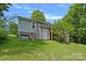 The backyard with green grass and luscious trees around at 2934 Drakes Crossing Dr, Charlotte, NC 28262