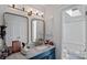 Stylish bathroom with a vanity, updated lighting, and a shower-tub combination at 2934 Drakes Crossing Dr, Charlotte, NC 28262