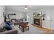 Cozy living room with a stone fireplace, plush seating, and natural light from a window at 2934 Drakes Crossing Dr, Charlotte, NC 28262