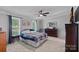 Spacious main bedroom features two windows, a ceiling fan, and a comfortable bed at 2934 Drakes Crossing Dr, Charlotte, NC 28262