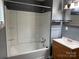 Bathroom features a shower-tub combo with grey walls and a wood vanity at 303 Southern Ave, East Spencer, NC 28039