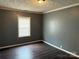 Bedroom featuring hardwood floors and a window for natural light, creating a comfortable and bright space at 303 Southern Ave, East Spencer, NC 28039