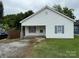 Charming single-story home with white siding, gray shutters, and a small front porch at 303 Southern Ave, East Spencer, NC 28039
