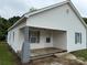 Side view of a charming single-story home with a wooden front porch and gray painted brick column at 303 Southern Ave, East Spencer, NC 28039