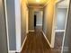 Hallway with hardwood floors connecting rooms for easy navigation throughout the house at 303 Southern Ave, East Spencer, NC 28039